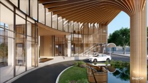 Modern building entrance with wooden architectural elements and large glass windows. A white car is parked at the drop-off area next to a reflective water feature and landscaped greenery.